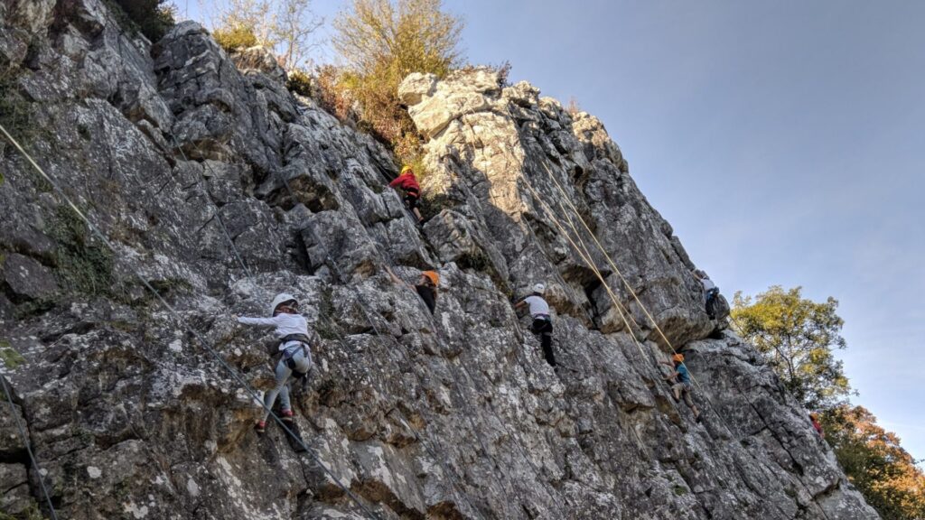 Des jeunes apprennent l'escalade sur une paroi rocheuse